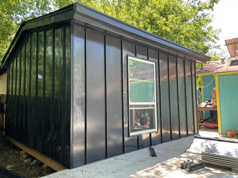 Black standing seam metal wall panels for Roof Inspection in Slaton