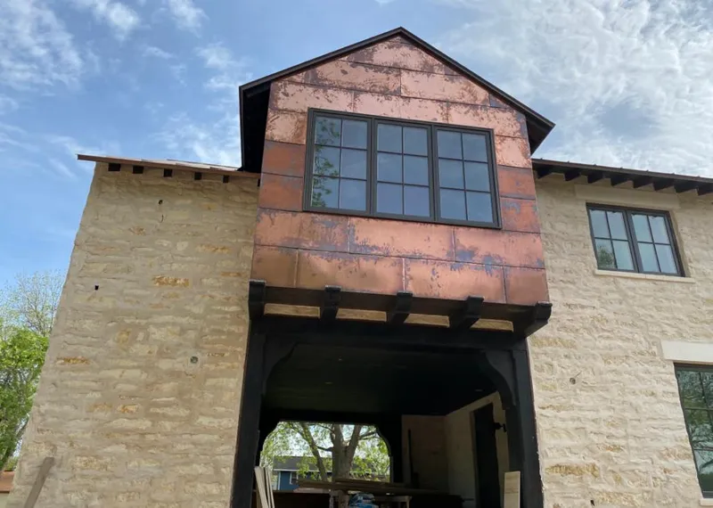 Copper metal panel facade on a stone building for Skylight Installation in Slaton